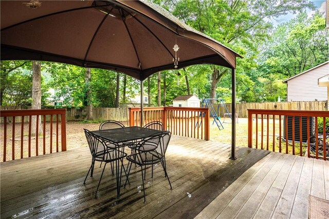 2568 Redfield Dr, Norcross, GA 30071 - wooden terrace with outdoor dining area, a fenced backyard, a gazebo, and view of scattered trees