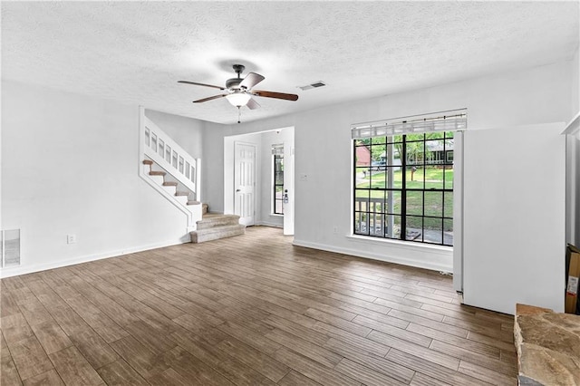 2568 Redfield Dr, Norcross, GA 30071 - entryway featuring ceiling fan, stairway, wood finished floors, a textured ceiling, and baseboards