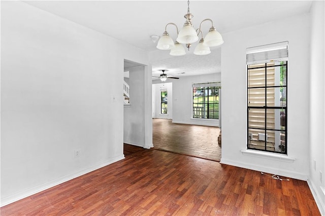2568 Redfield Dr, Norcross, GA 30071 - unfurnished dining area featuring a chandelier, wood finished floors, baseboards, and a ceiling fan