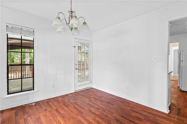 2568 Redfield Dr, Norcross, GA 30071 - unfurnished room featuring wood finished floors, a chandelier, and baseboards