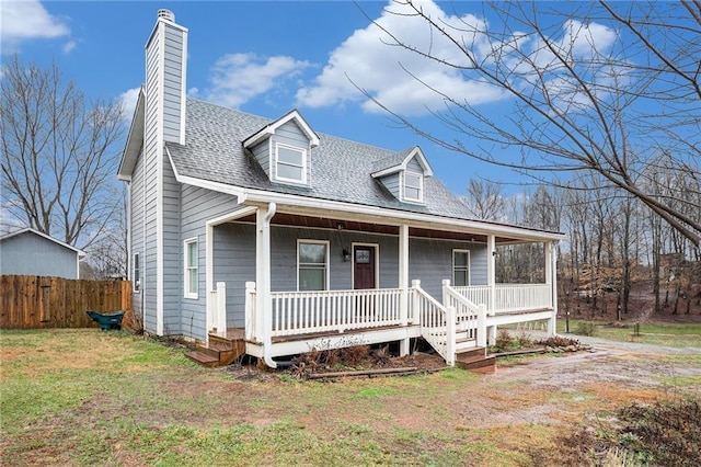 view of front of house with covered porch and a front lawn