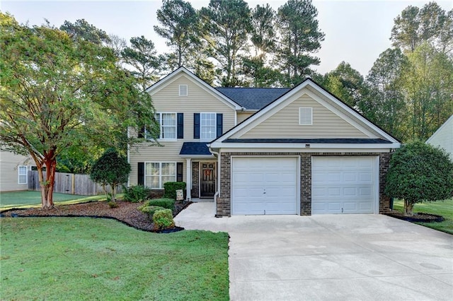 traditional-style house with concrete driveway, an attached garage, fence, and a front yard