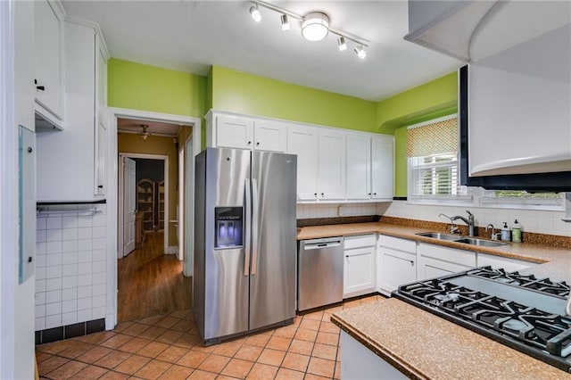 407 E College St E, Bowdon, GA 30108 - kitchen with stainless steel appliances, white cabinets, light tile patterned floors, and tasteful backsplash
