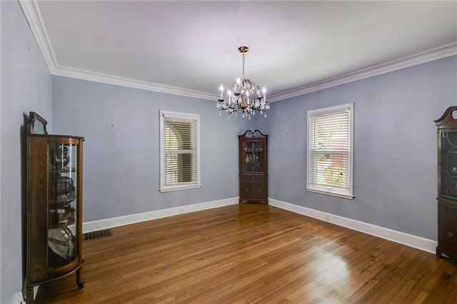 407 E College St E, Bowdon, GA 30108 - empty room featuring a chandelier, wood finished floors, and ornamental molding