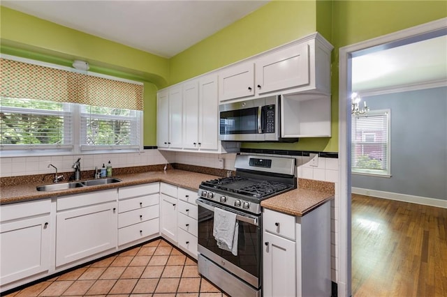407 E College St E, Bowdon, GA 30108 - kitchen featuring appliances with stainless steel finishes, tasteful backsplash, and plenty of natural light