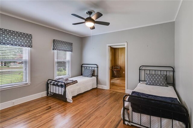407 E College St E, Bowdon, GA 30108 - bedroom with light wood-style floors, crown molding, and ceiling fan
