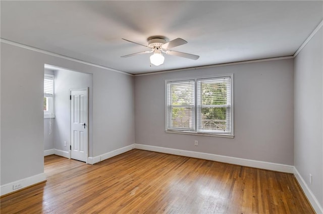 407 E College St E, Bowdon, GA 30108 - empty room featuring plenty of natural light, a ceiling fan, light wood finished floors, and crown molding