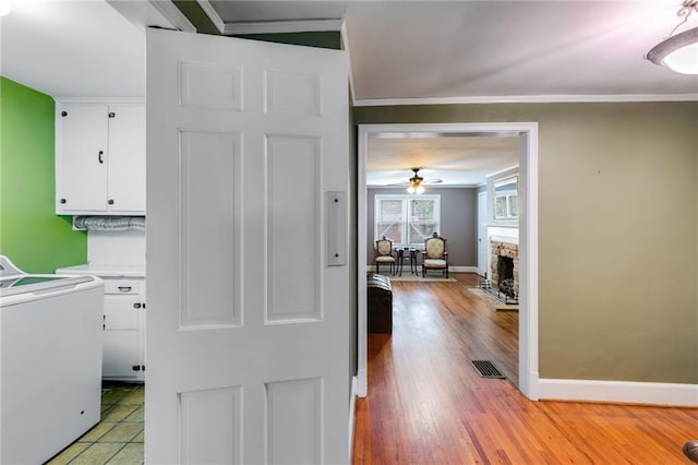 407 E College St E, Bowdon, GA 30108 - laundry area with washer / clothes dryer, cabinet space, ornamental molding, a ceiling fan, and light wood-type flooring