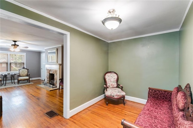 407 E College St E, Bowdon, GA 30108 - living area with wood finished floors, crown molding, a fireplace, and ceiling fan