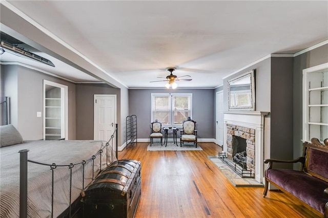 407 E College St E, Bowdon, GA 30108 - living area featuring ceiling fan, a fireplace, light wood-style floors, and crown molding