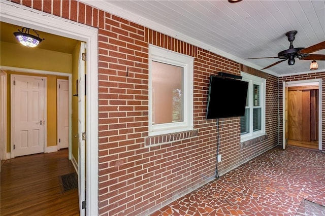 407 E College St E, Bowdon, GA 30108 - doorway to property featuring a ceiling fan and brick siding