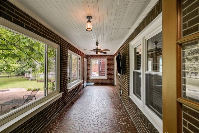 407 E College St E, Bowdon, GA 30108 - unfurnished sunroom with brick wall, a ceiling fan, wood ceiling, and crown molding