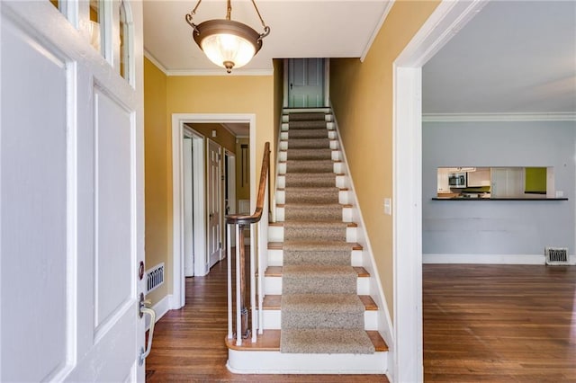 407 E College St E, Bowdon, GA 30108 - foyer with wood finished floors, stairway, and crown molding