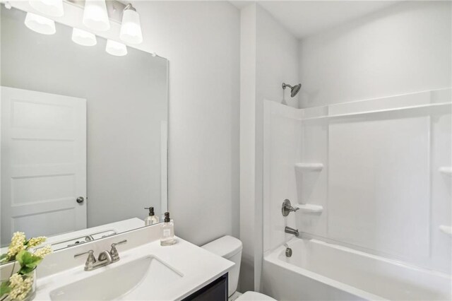 full bath with toilet, vanity, and shower / tub combination