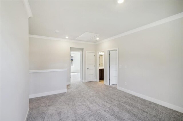 unfurnished room with recessed lighting, light carpet, crown molding, and baseboards