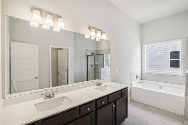 full bath featuring a stall shower, a bath, and double vanity