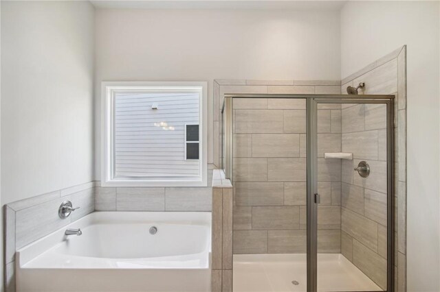 bathroom featuring a garden tub and a stall shower