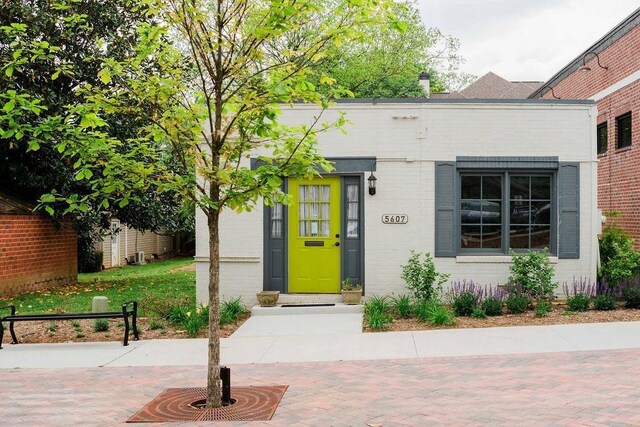 property entrance featuring brick siding