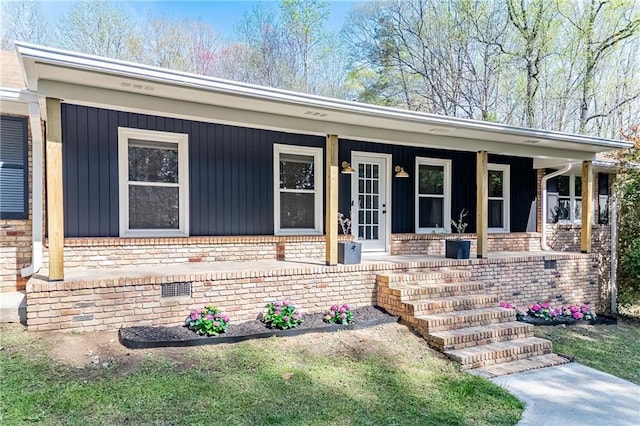 view of front of home featuring covered porch and brick siding