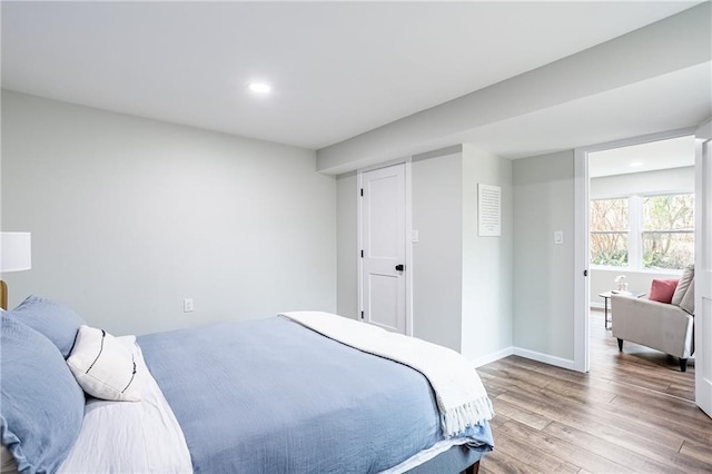 bedroom featuring recessed lighting, baseboards, and light wood-style floors