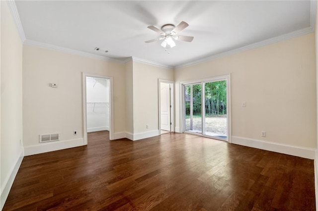 unfurnished room featuring ornamental molding, dark wood finished floors, visible vents, and baseboards