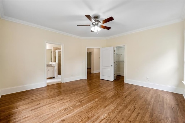 unfurnished bedroom featuring baseboards, ornamental molding, and light wood-style floors