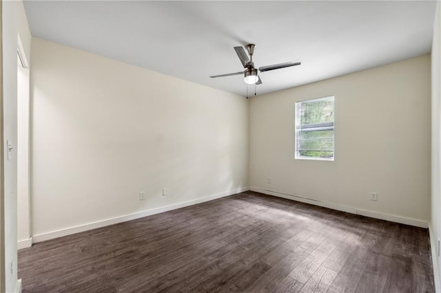 empty room featuring a ceiling fan, dark wood finished floors, and baseboards