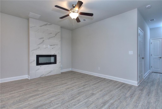 119 Greenview Ct Unit 1303, Homer, GA 30547 - unfurnished living room with wood finished floors, a ceiling fan, and a premium fireplace