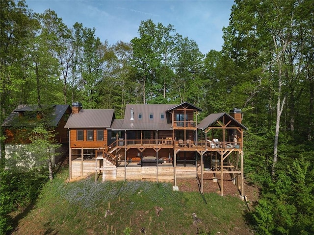851 N Moreland Dr N, Blue Ridge, GA 30513 - back of property with stairway, a wooden deck, a chimney, and metal roof