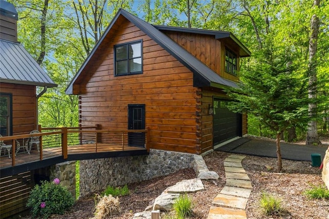 851 N Moreland Dr N, Blue Ridge, GA 30513 - view of side of home featuring a garage, a deck, a chimney, and metal roof
