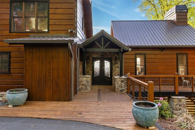 851 N Moreland Dr N, Blue Ridge, GA 30513 - entrance to property with stone siding, a deck, a chimney, french doors, and metal roof