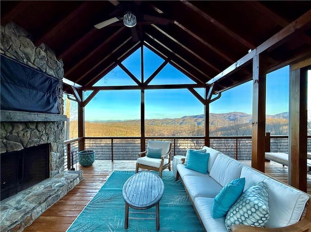 interior space with ceiling fan, a gazebo, a mountain view, and an outdoor hangout area