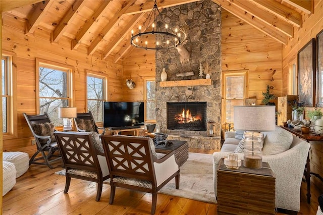 851 N Moreland Dr N, Blue Ridge, GA 30513 - living room featuring wooden walls, wood-type flooring, a stone fireplace, and a notable chandelier