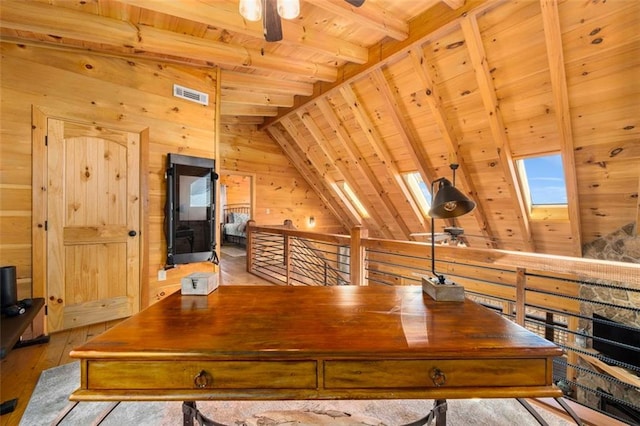 home office with lofted ceiling with skylight, wood walls, light hardwood / wood-style floors, ceiling fan, and wooden ceiling