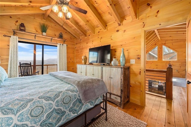 bedroom featuring light wood-type flooring, vaulted ceiling with beams, access to outside, and wood walls