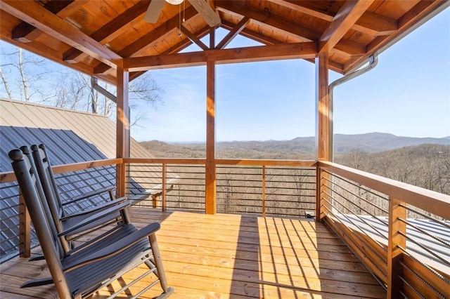 deck featuring a mountain view and ceiling fan