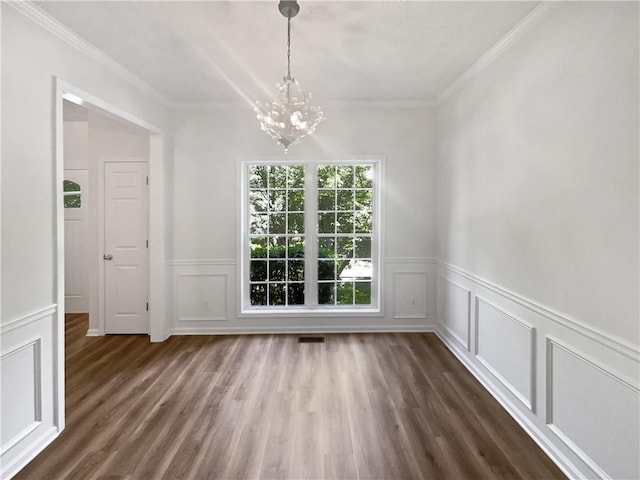 200 Eagle Glen Ct, Woodstock, GA 30189 - unfurnished dining area featuring a chandelier, dark wood-style flooring, crown molding, a decorative wall, and wainscoting