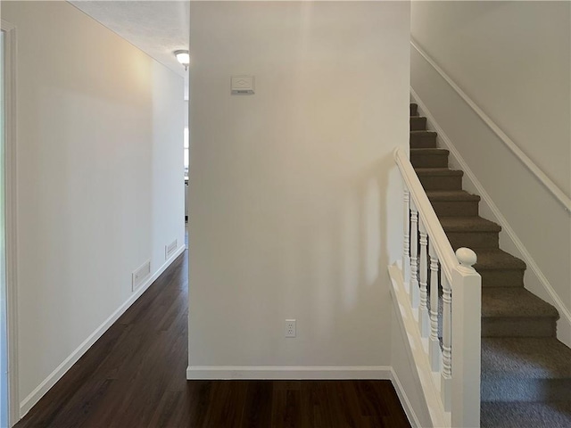 staircase with wood-type flooring