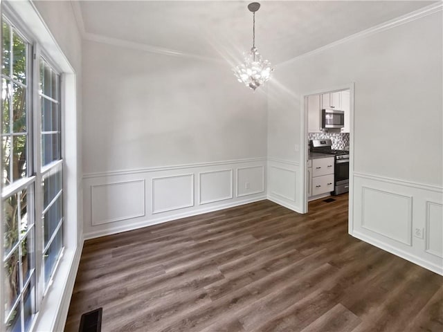 200 Eagle Glen Ct, Woodstock, GA 30189 - unfurnished dining area featuring a chandelier, ornamental molding, a decorative wall, dark wood finished floors, and a wainscoted wall