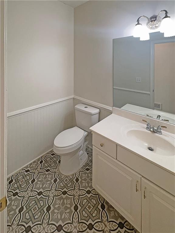 bathroom with vanity, toilet, and tile patterned flooring