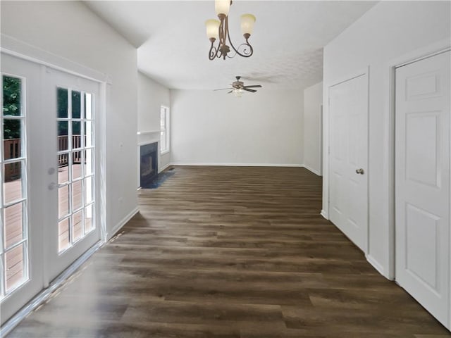 200 Eagle Glen Ct, Woodstock, GA 30189 - unfurnished living room with a chandelier, a fireplace with flush hearth, dark wood-type flooring, baseboards, and a ceiling fan