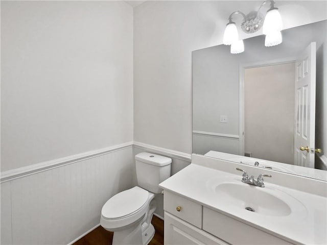 200 Eagle Glen Ct, Woodstock, GA 30189 - bathroom featuring toilet, vanity, and a wainscoted wall