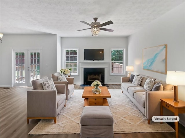 200 Eagle Glen Ct, Woodstock, GA 30189 - living room featuring wood finished floors, ceiling fan, plenty of natural light, a textured ceiling, and a fireplace with flush hearth