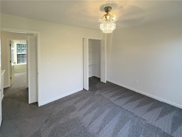 unfurnished bedroom with ceiling fan and dark colored carpet