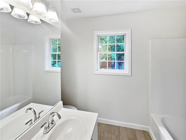 200 Eagle Glen Ct, Woodstock, GA 30189 - full bath with healthy amount of natural light, vanity, wood finished floors, and baseboards