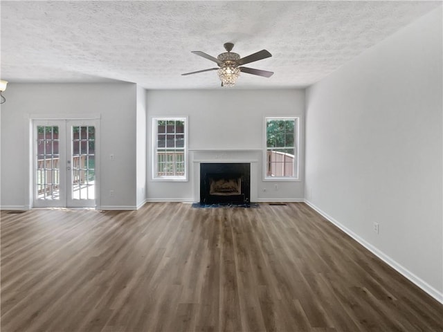 200 Eagle Glen Ct, Woodstock, GA 30189 - unfurnished living room featuring wood finished floors, baseboards, a textured ceiling, ceiling fan, and a fireplace with flush hearth