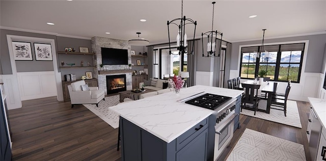 kitchen featuring stainless steel range, light stone countertops, and hanging light fixtures