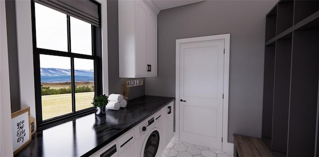 laundry room with light tile patterned floors and cabinets