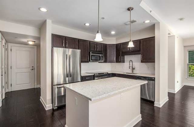 kitchen with stainless steel appliances, visible vents, a sink, and dark brown cabinets