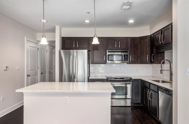 kitchen featuring dark brown cabinetry, dark wood-style floors, stainless steel appliances, and a sink